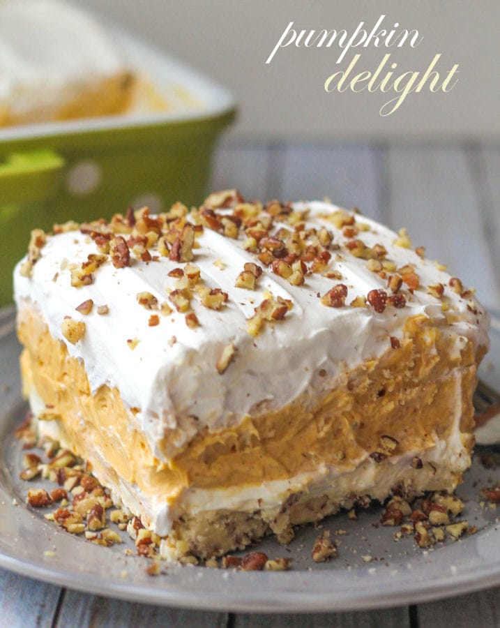 Creamy and Cool Pumpkin Delight with so many delicious layers - everyone will love it! { lilluna.com } Recipe includes whipped topping, pecans, pumpkin spice, pumpkin puree, cream cheese and white chocolate instant pudding mix.