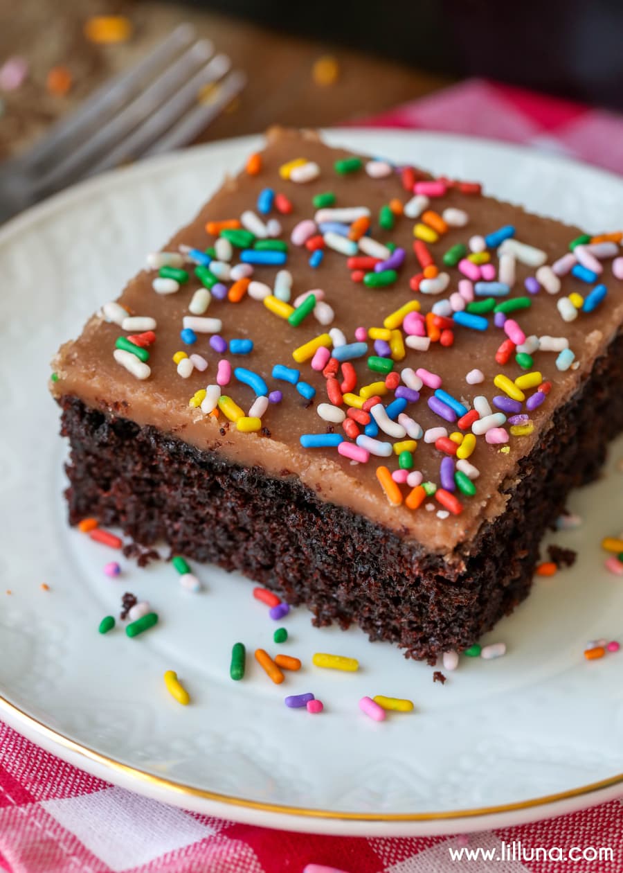 Valentines Dinner Ideas - Chocolate sheet cake with chocolate frosting and multi colored sprinkles on a white plate. 
