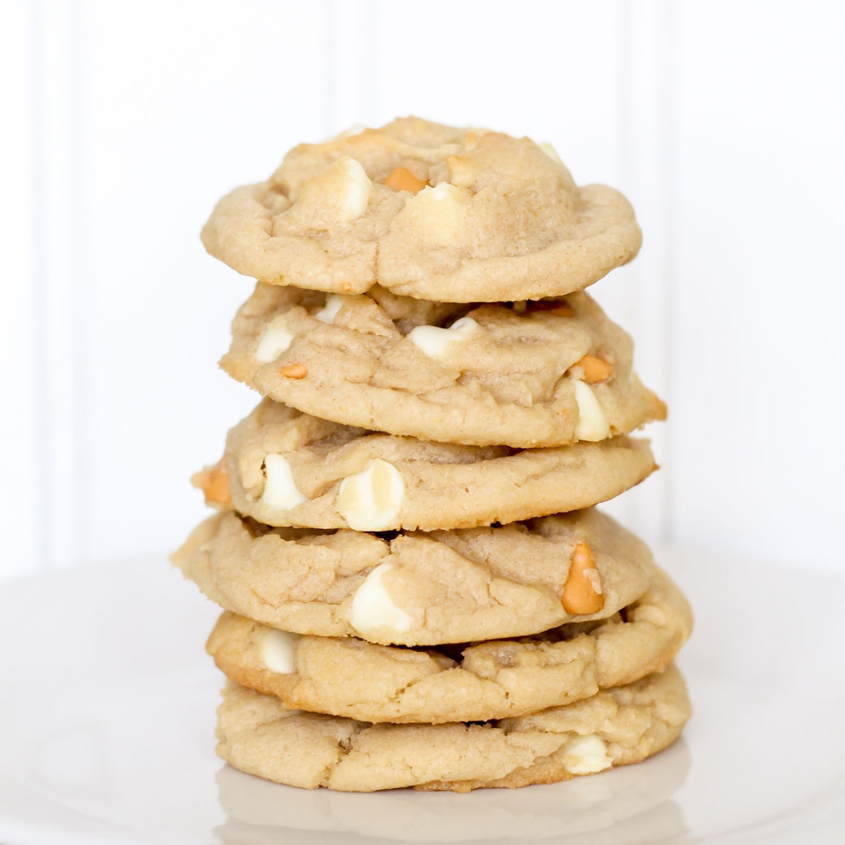 White chocolate butterscotch chip cookies stacked on plate