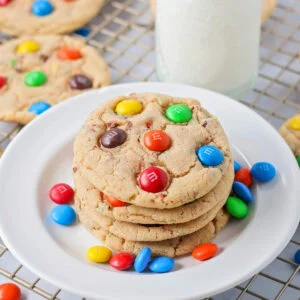 M&M cookie recipe stacked on top of each other on white plate.
