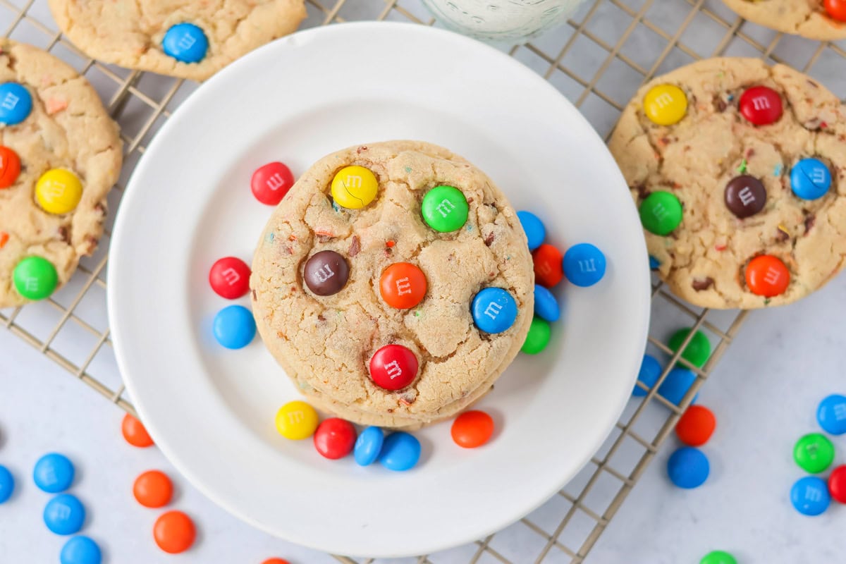 M&M Cookies recipe stacked on each other on white plate.