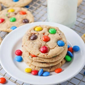 M&M Cookie recipe stacked on top of each other on white plate.