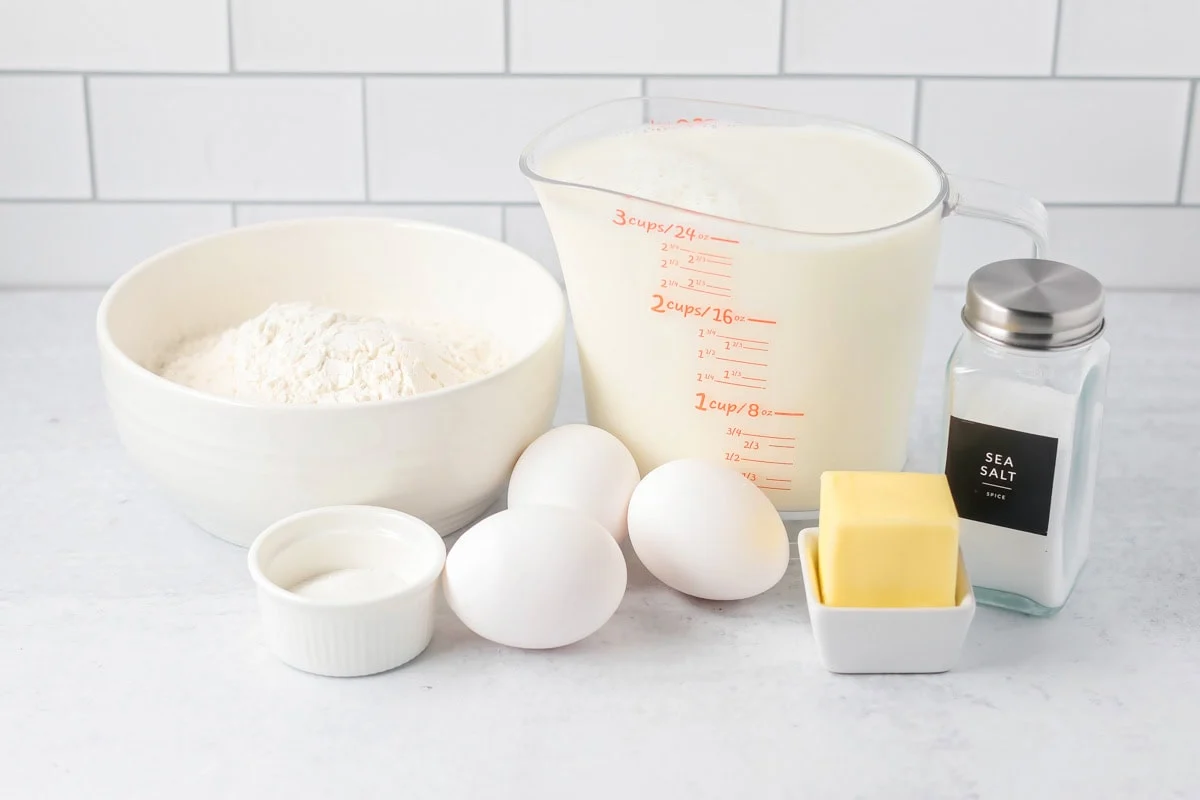 Handed down for generations, this homemade Swedish pancakes recipe is the softest, most delicious. Add a sweet or savory filling! Swedish pancakes ingredients on counter.