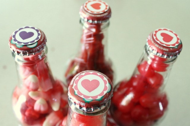 Capped bottles with heart stickers applied to the cap