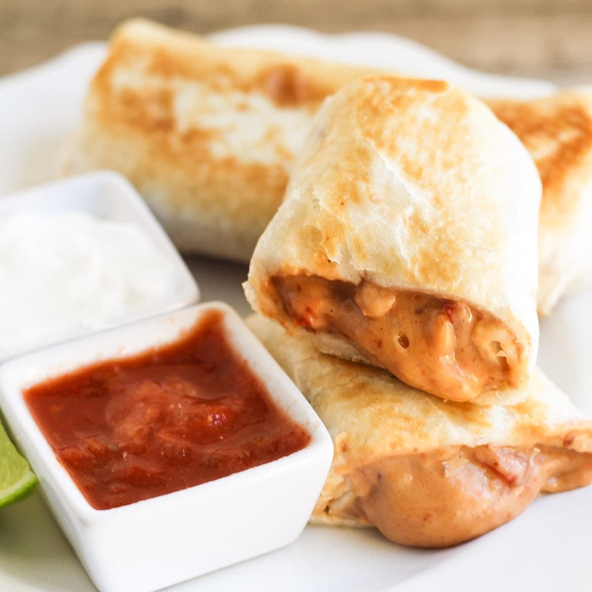 Bean chimichanga cut in half and served with salsa