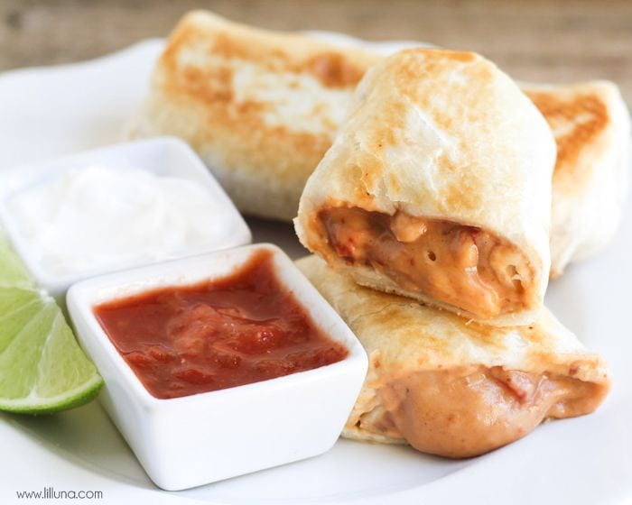 Easy Dinner Ideas - Mean chimichanga cut in half with salsa and sour cream on the side.