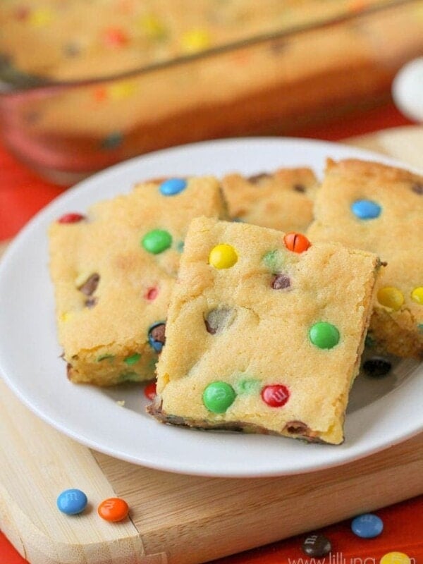 cake mix cookie bars with M&Ms on white plate