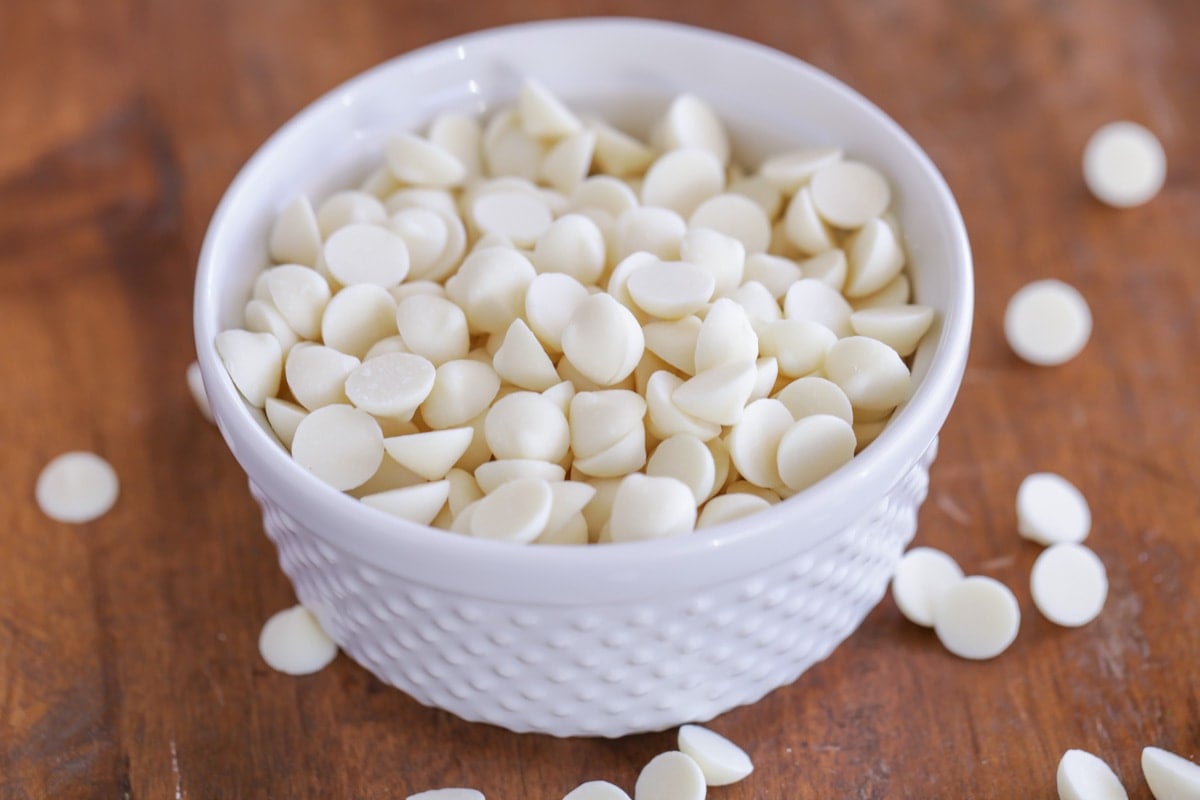 A bowl of white chocolate chips to use in white chocolate snickerdoodle recipe