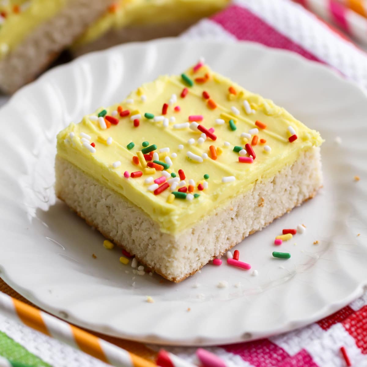 Thanksgiving desserts - a square of sugar cookie bars topped with yellow frosting and sprinkles.