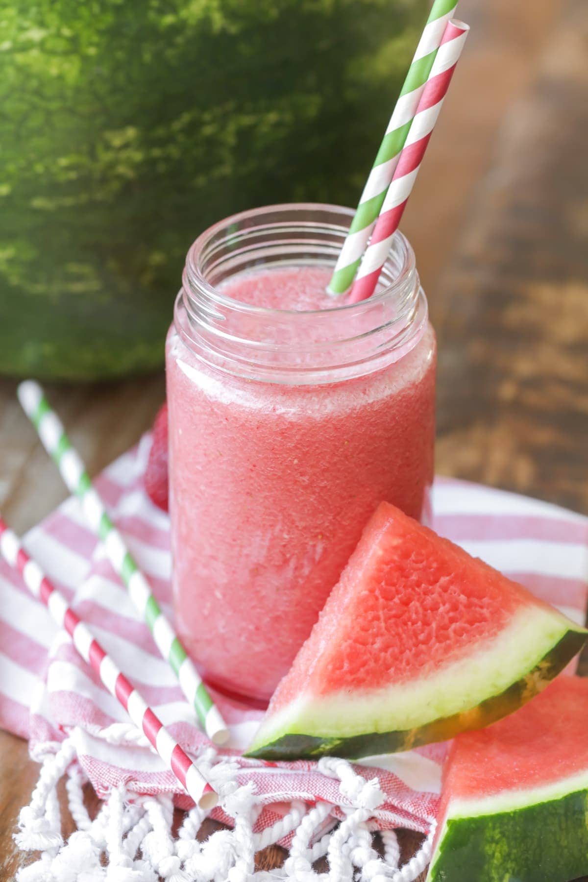 Watermelon juice recipe in glass with straws and fruit