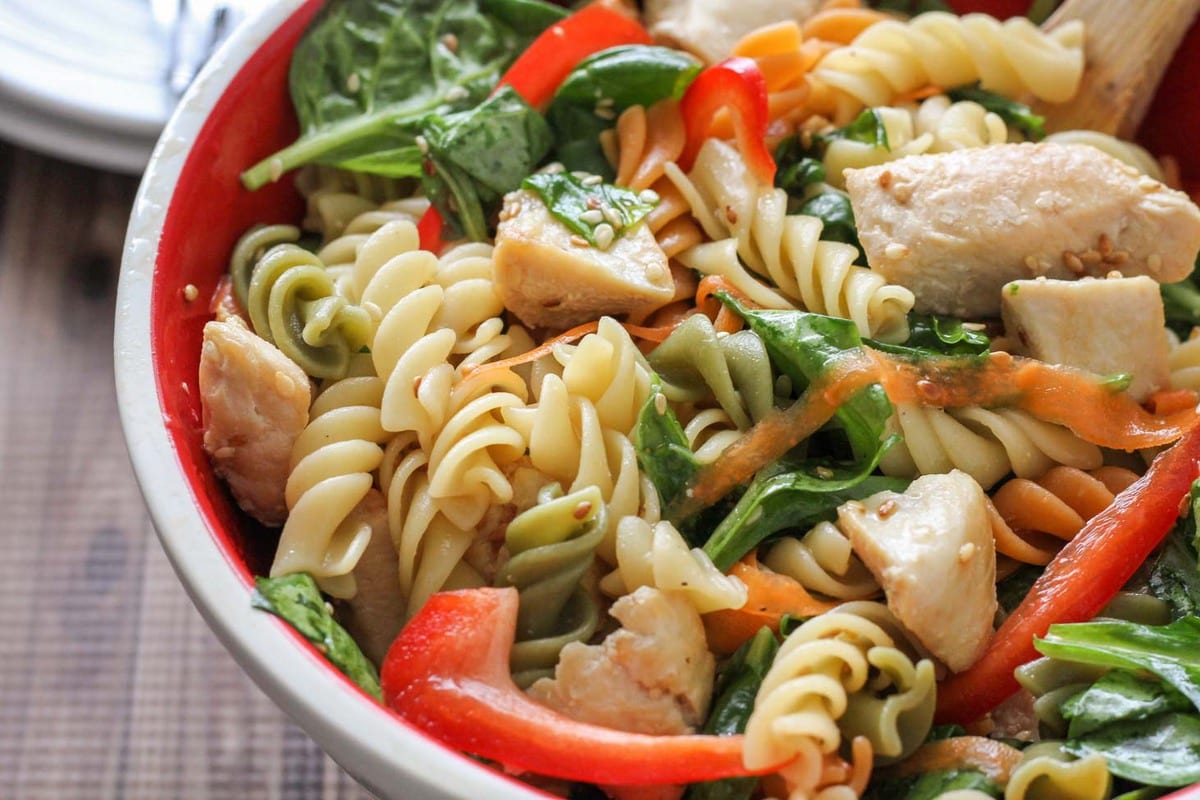 Asian Pasta Salad served in a white and red bowl