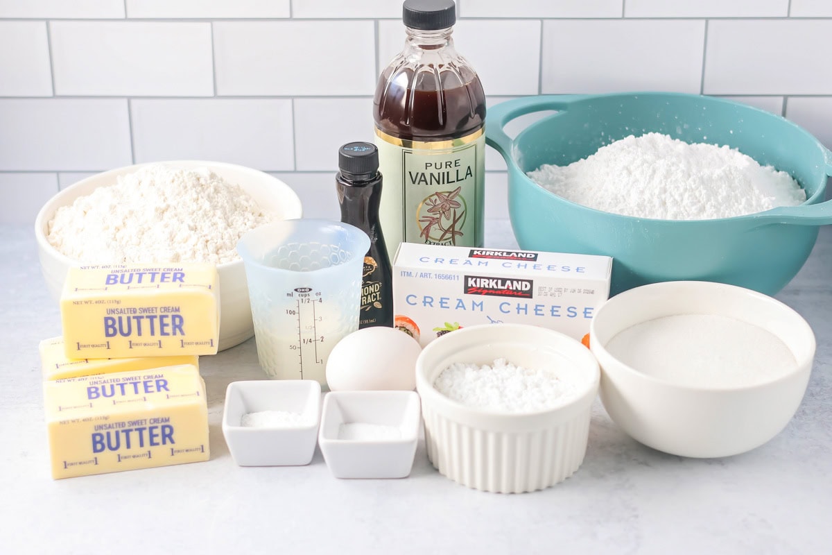 Frosted sugar cookies ingredients on counter.