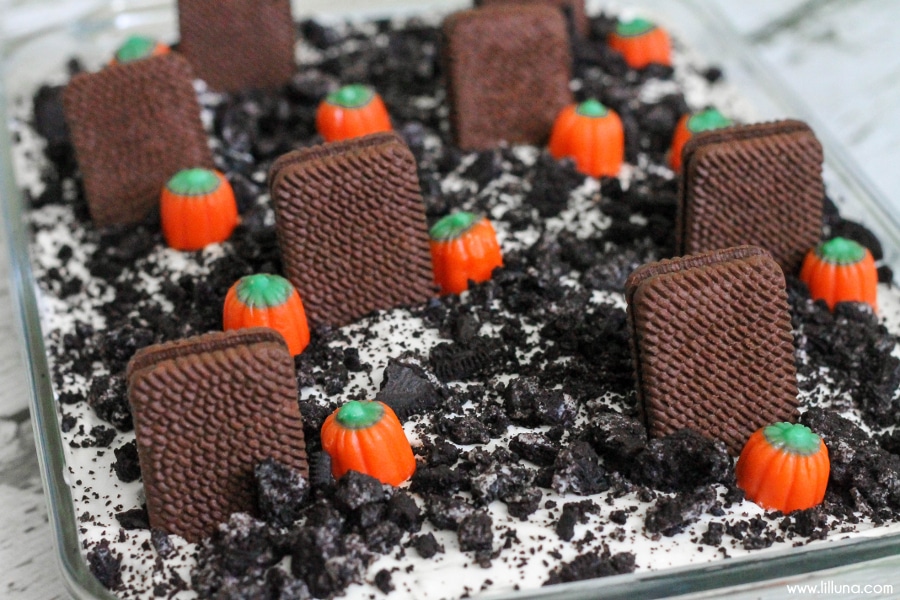 A glass baking dish filled with graveyard dessert.