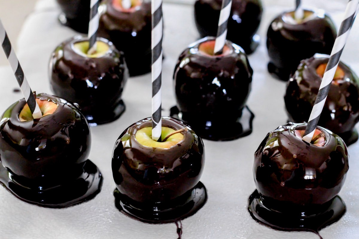 coated halloween candy apples on parchment paper