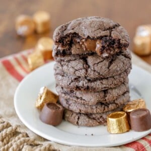 Gooey Rolo cookies stacked on a white plate.