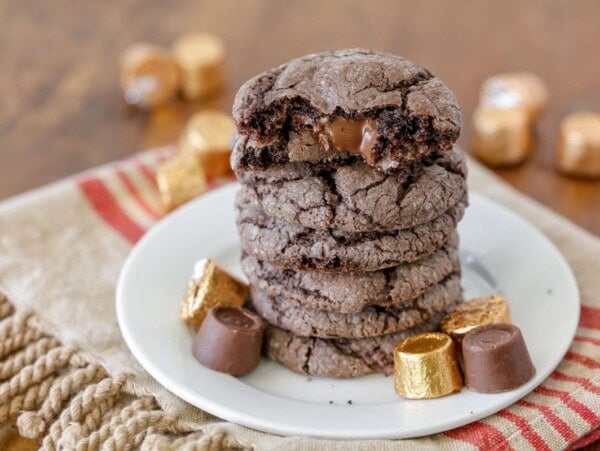 Gooey Rolo cookies stacked on a white plate.