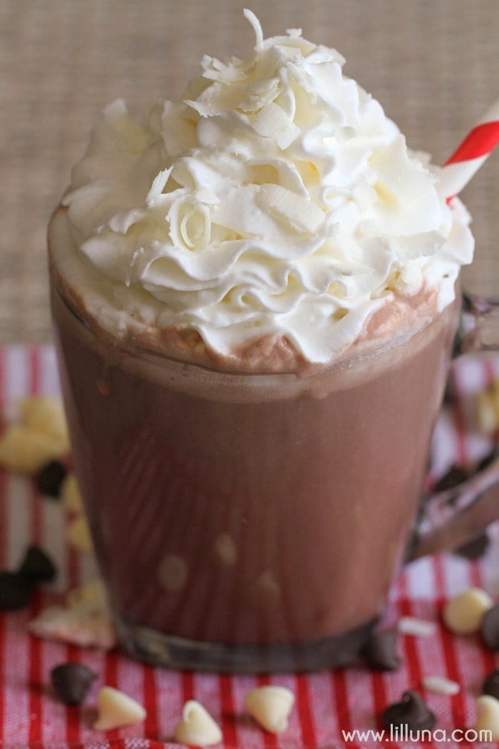 Close up of double chocolate hot cocoa topped with whipped cream and white chocolate shavings.