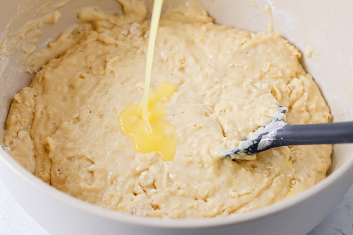 Mixing cinnamon roll cake ingredients in mixing bowl.