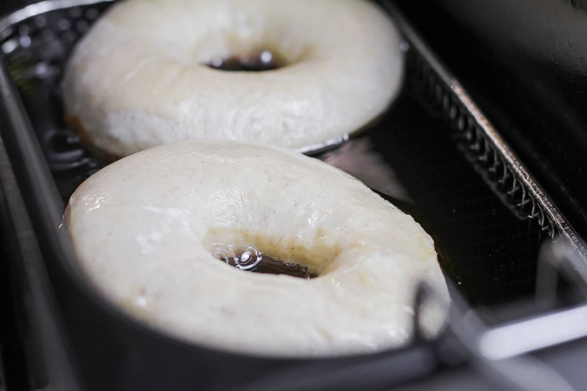 Donuts being fried in oil.