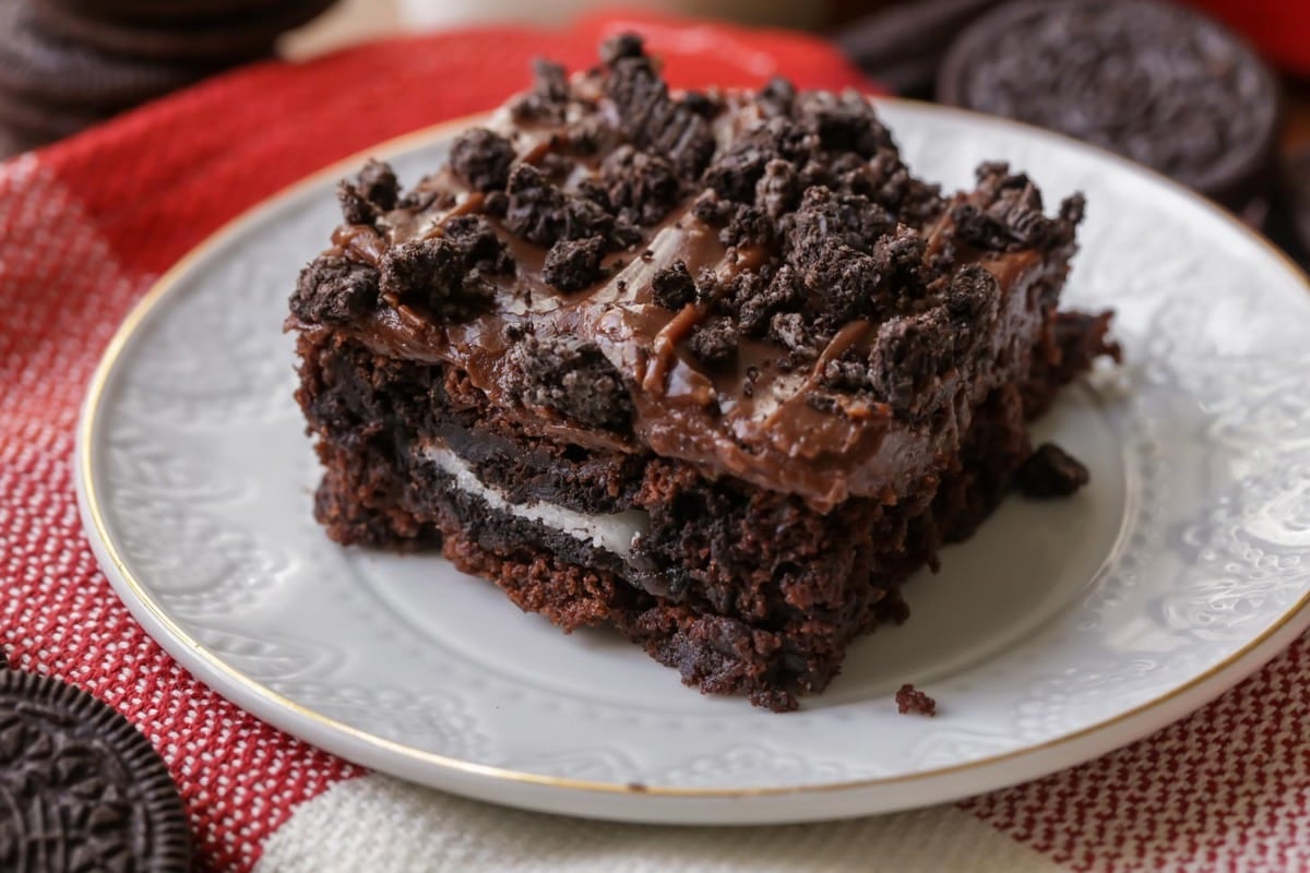Oreo Brownie topped with chocolate frosting and Oreo on a white plate