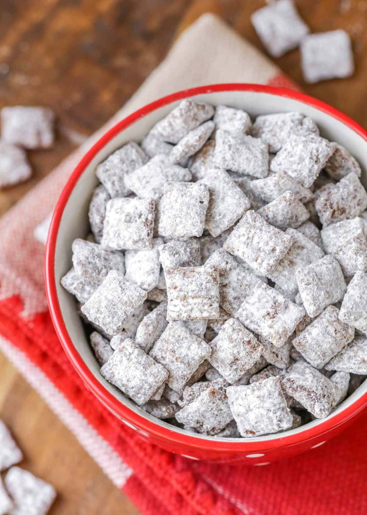 Sweet and salty chex mix - a red bowl filled with puppy chow.