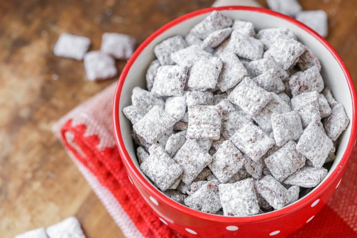 powder sugar coated chex in a red bowl