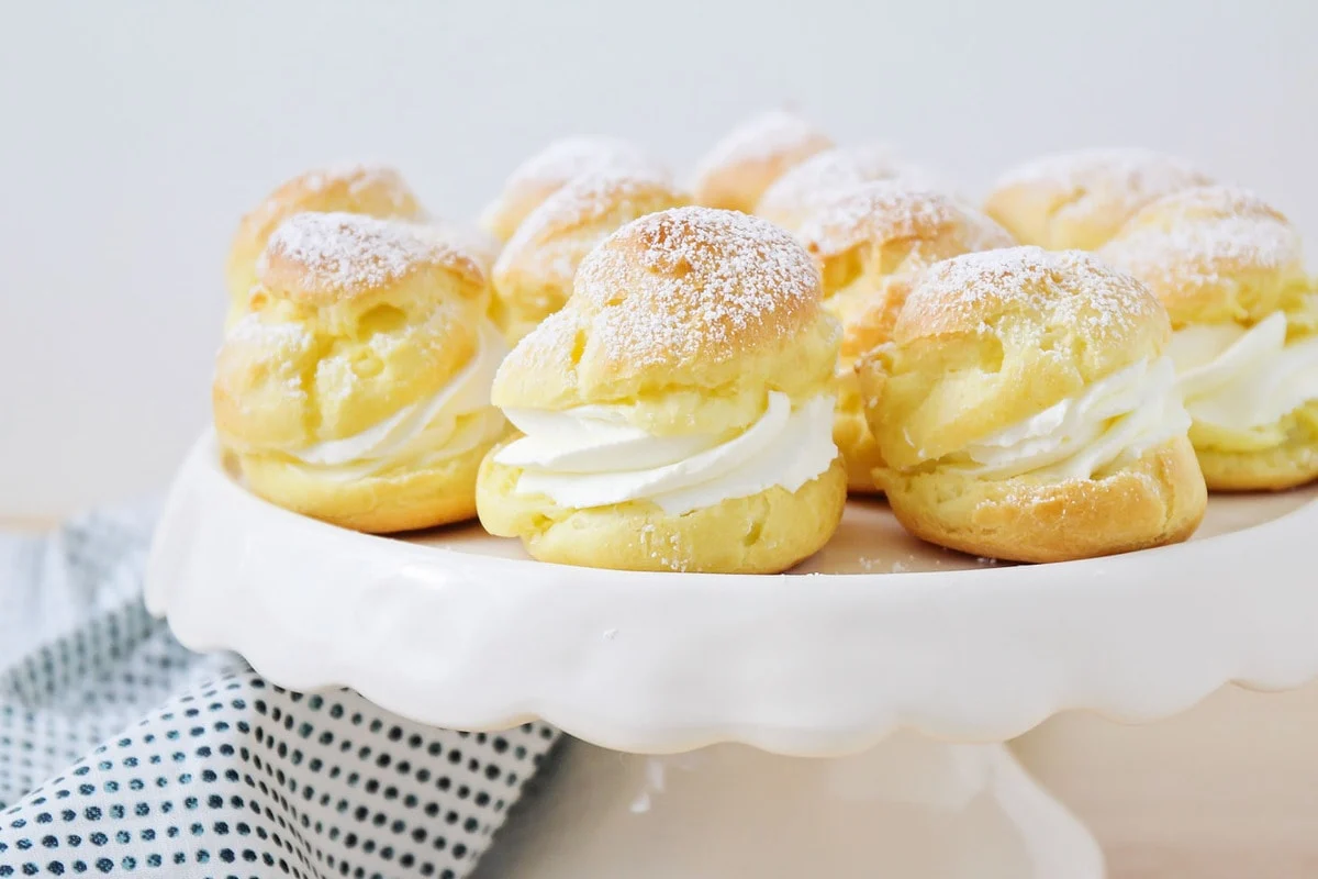 Homemade Cream Puff recipe served on a cake stand.