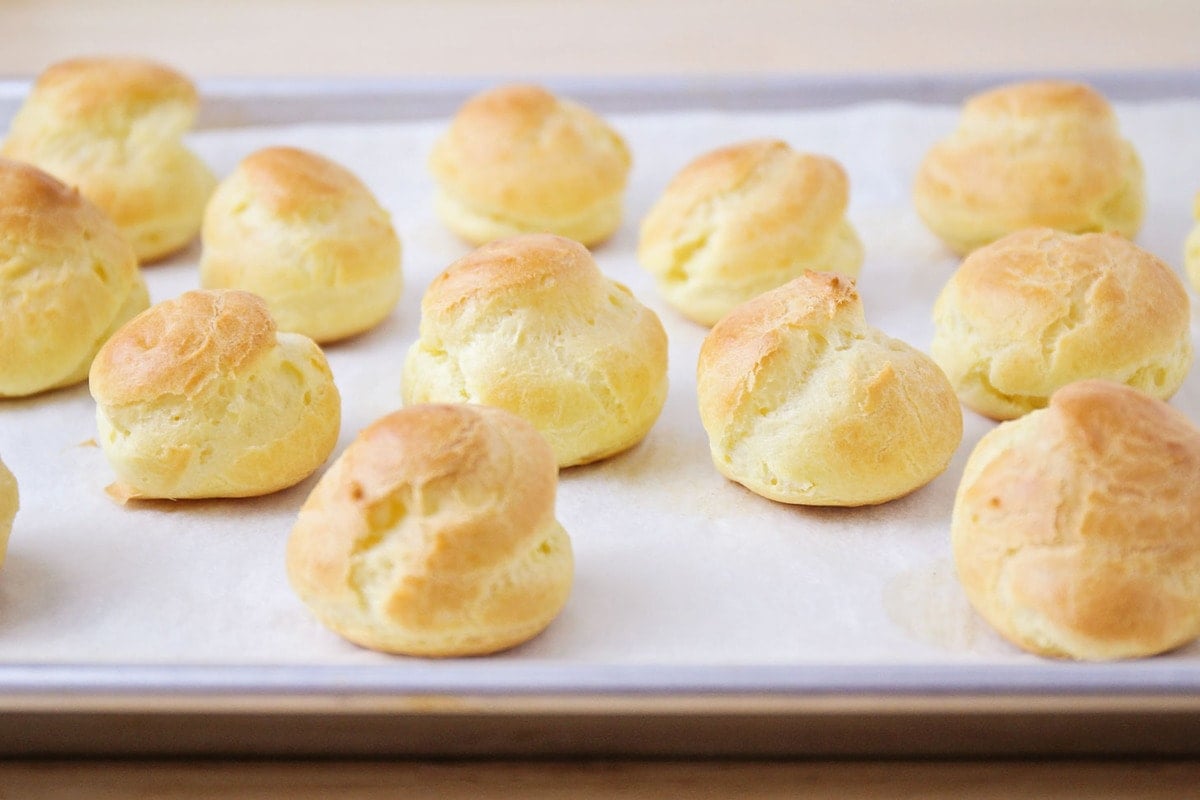 Cream Puff shells baked on cookie sheet.