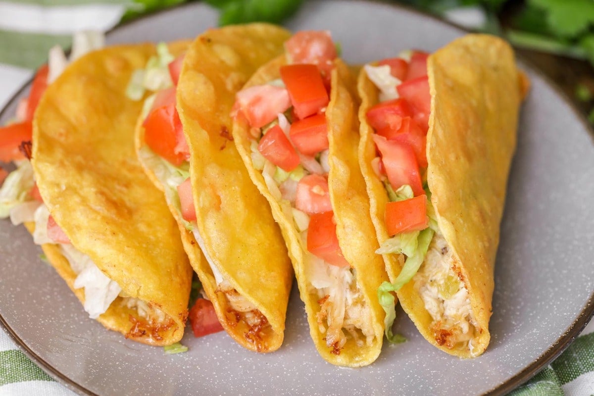 Chicken Tacos  on a grey silver rimmed plate - Mexican dinner recipes.