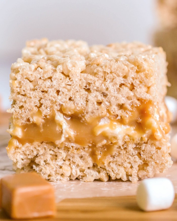 Close up of crack rice krispie with gooey caramel and marshmallow center