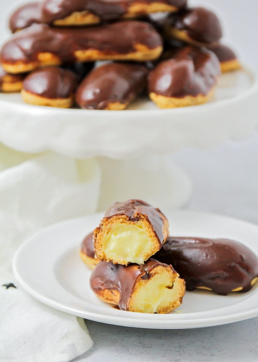 Chocolate eclairs on a white plate