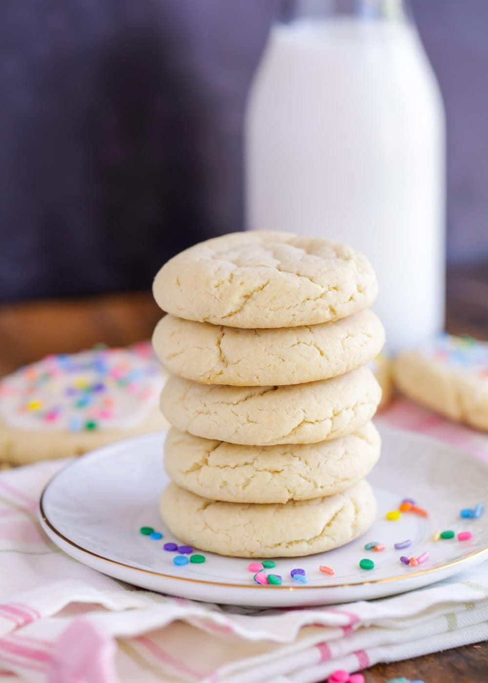 A stack of soft and chewy sugar cookies on a plate