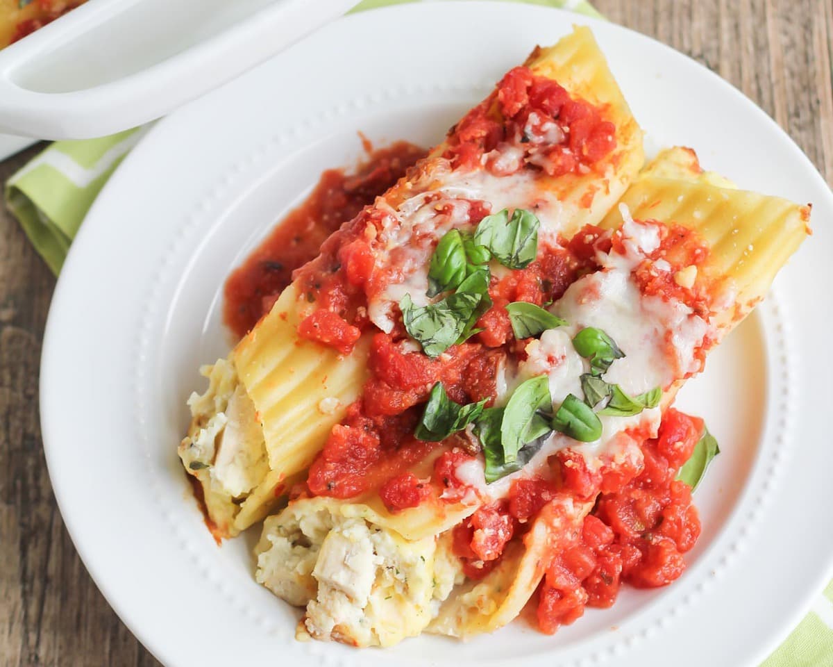 Plate of chicken manicotti topped with melted cheese.