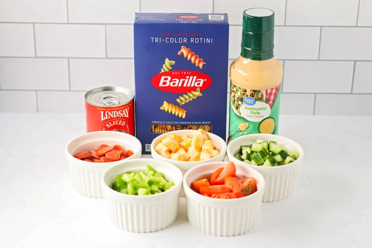 Pasta Salad with Italian Dressing ingredients on counter.