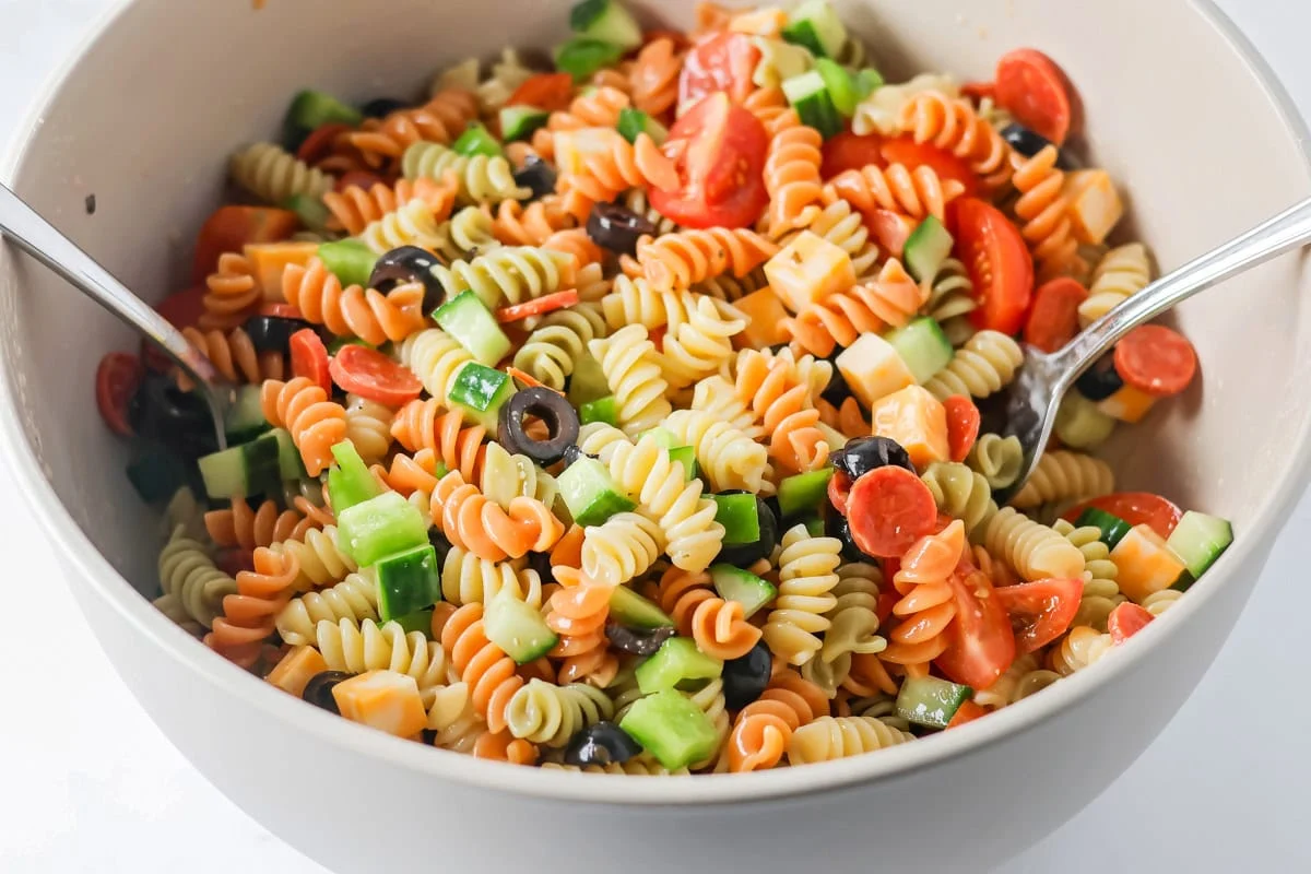 Pasta salad with Italian Dressing mixed together in bowl.