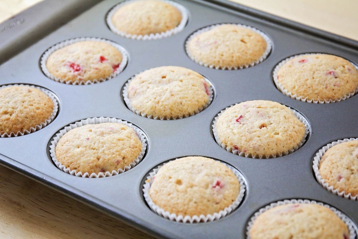 Baked fresh Strawberry Cupcakes in muffin tin.