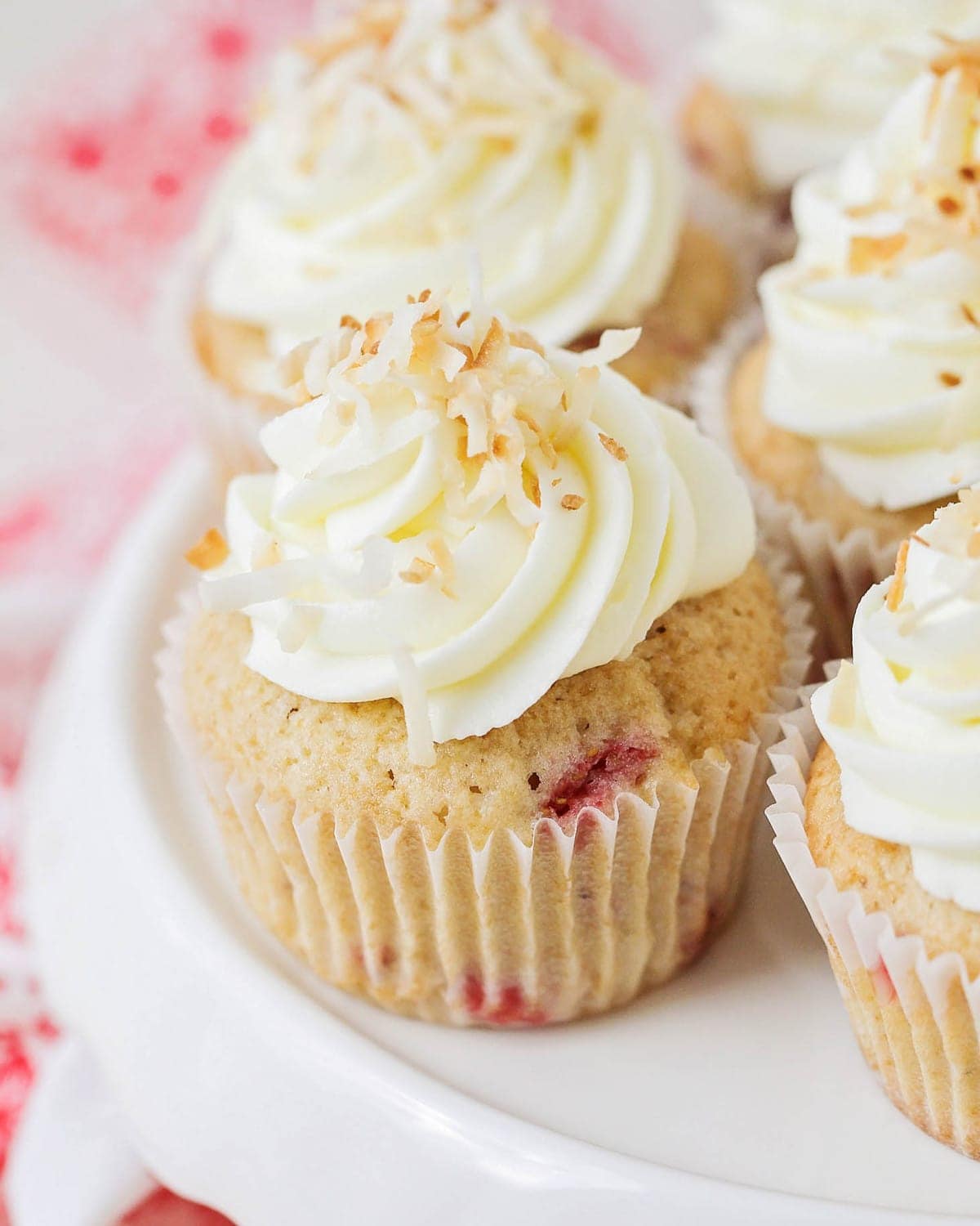 Fresh Strawberry cupcakes topped with cream cheese frosting and coconut.