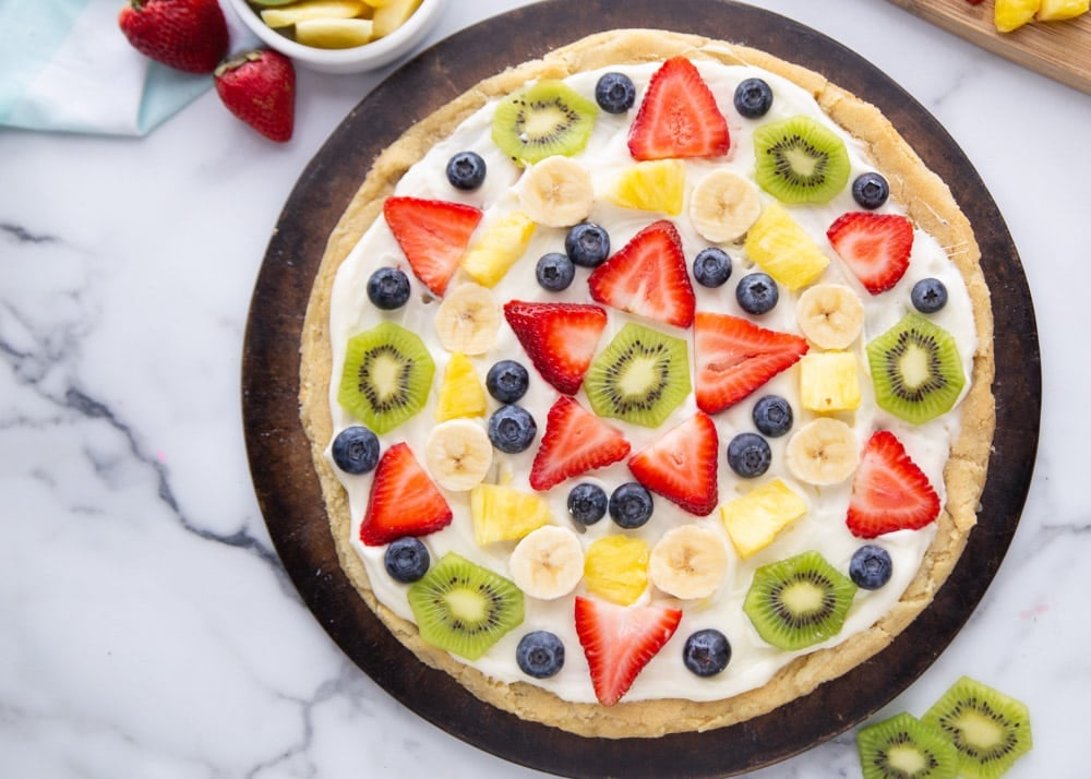 4th of July Recipes - Fruit pizza topped with berries, kiwi, pineapple, and bananas. 