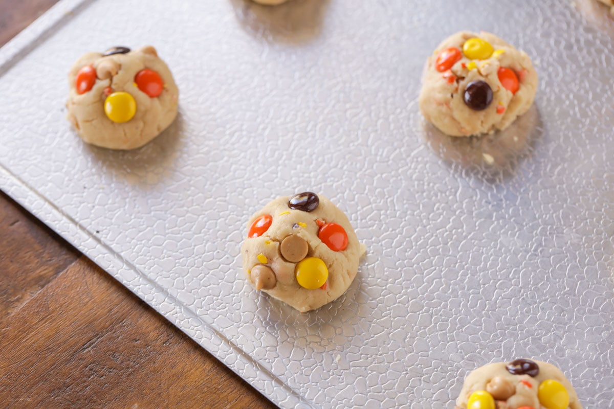 Reese's Pieces cookie dough on a baking sheet