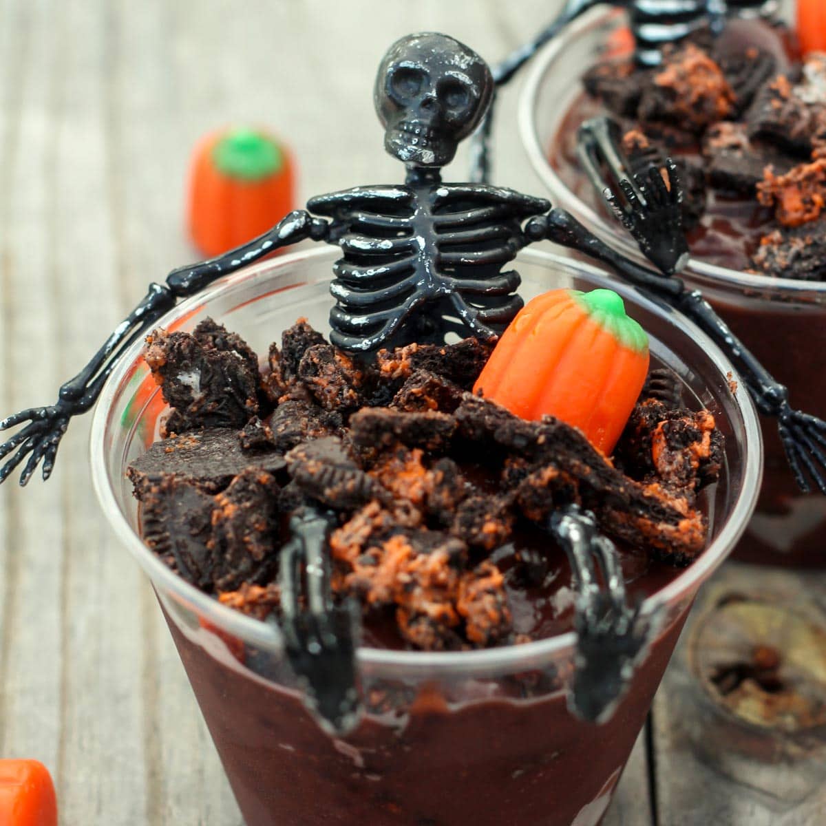Halloween dinner ideas - skeleton pudding cups topped with crushed Halloween Oreos.