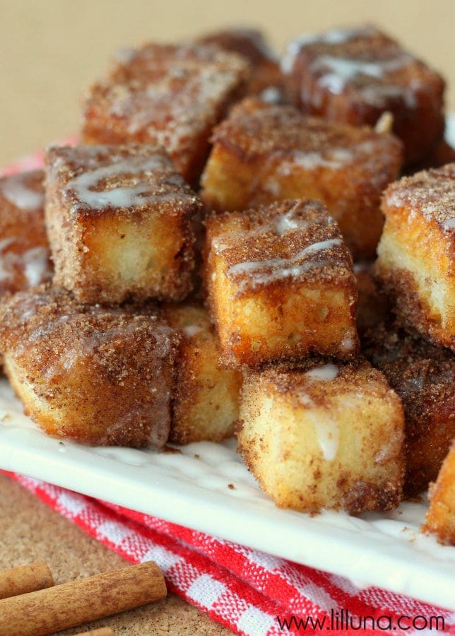 Angel Food Cake Churro Bites stacked on a white plate