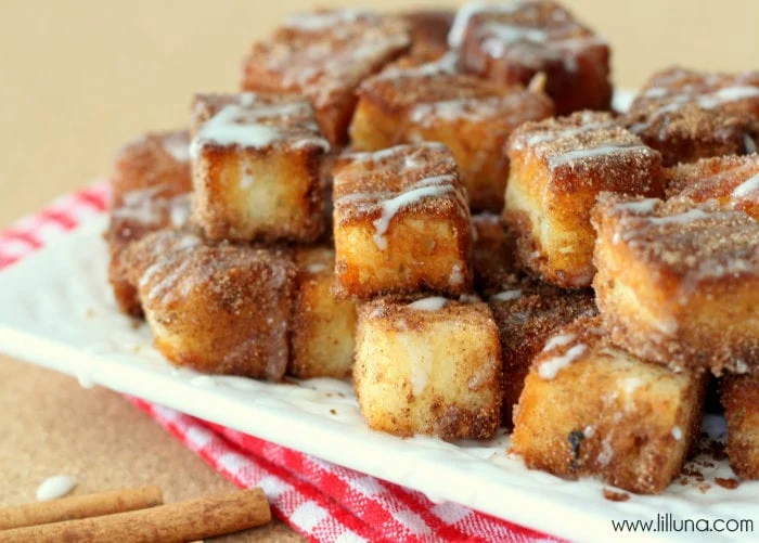 Angel Food Cake Churro Bites stacked on a white plate