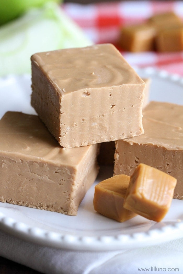 pieces of caramel apple fudge stacked on a white plate