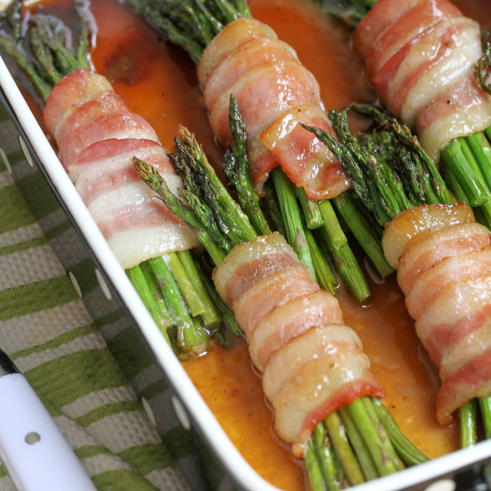 4th of July Side Dishes - Bacon wrapped asparagus bundles in a serving dish.