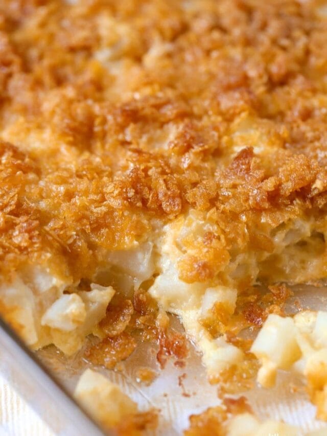Thanksgiving dinner ideas - a casserole dish of funeral potatoes with a missing scoop.