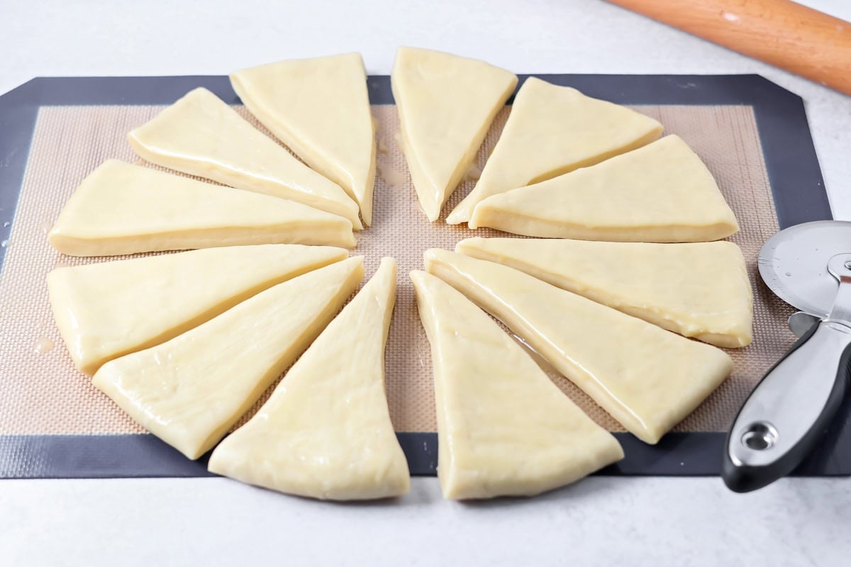 Homemade dinner rolls cut like a pizza to be rolled and baked.