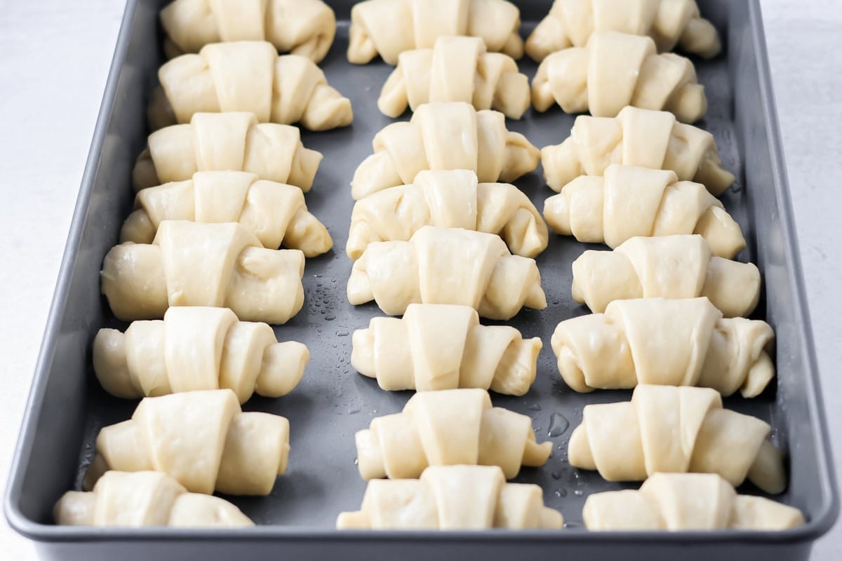 Dinner rolls rolled in baking pan.