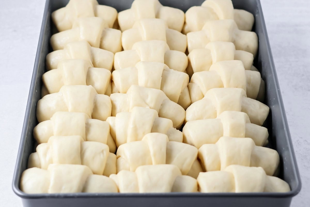 Dinner rolls raised in baking pan.
