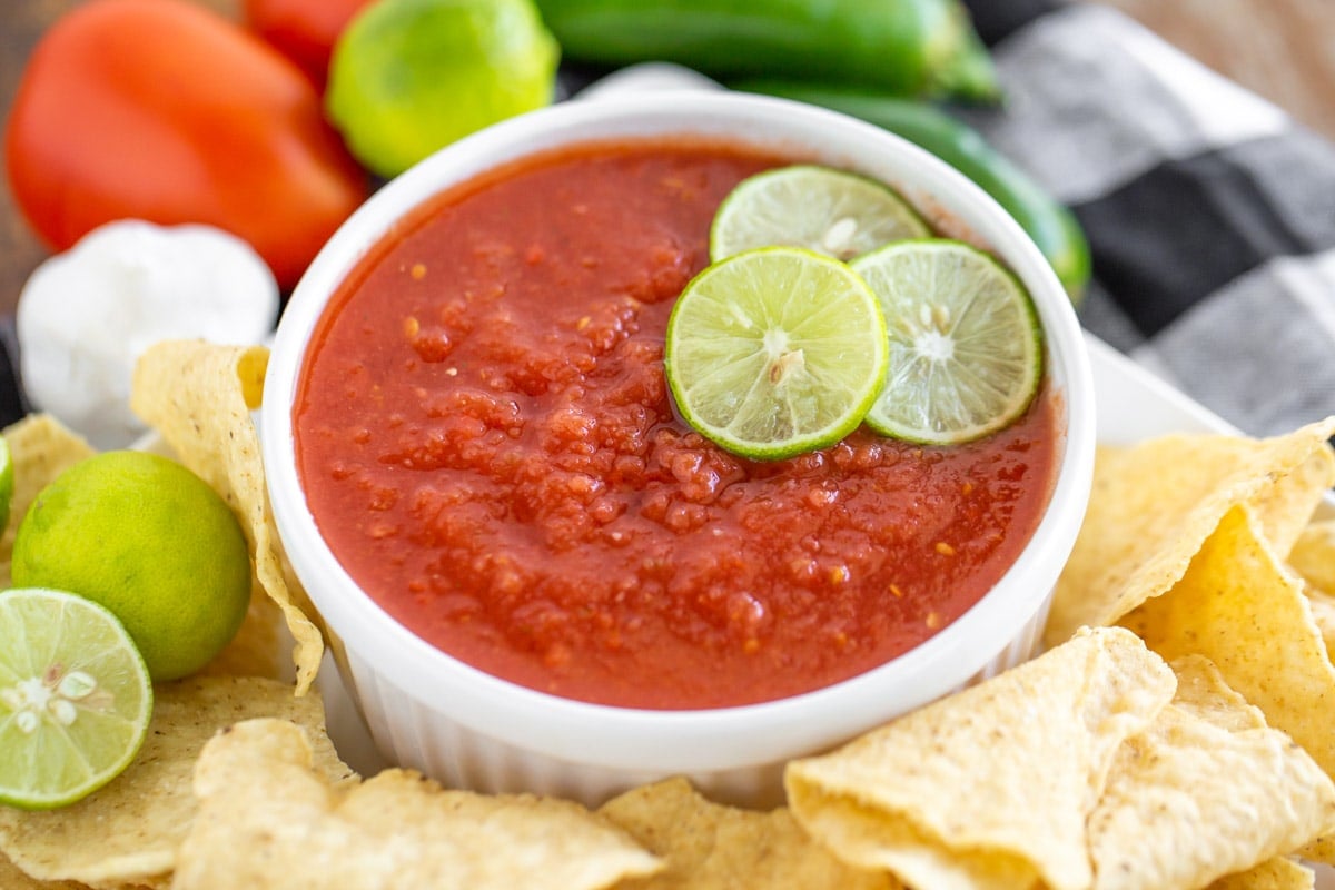Appetizer Dips - Red Salsa in a white ramekin topped with three lime slices.