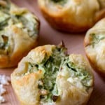 A few spinach cheese puffs on a tray.